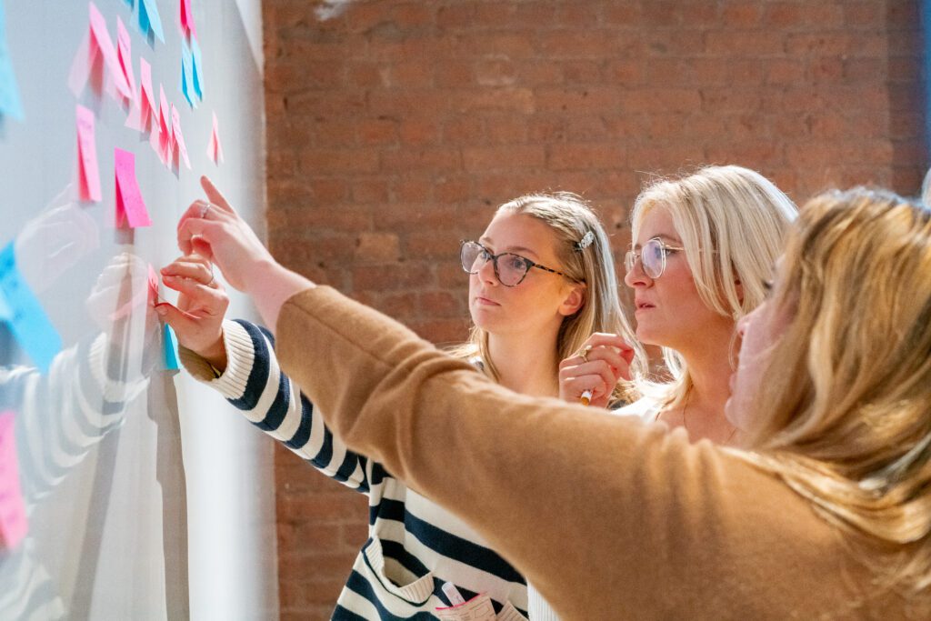 Colleagues collaborating over an ideas board