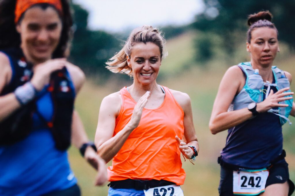 A group of female athletes running a marathon in the nature.