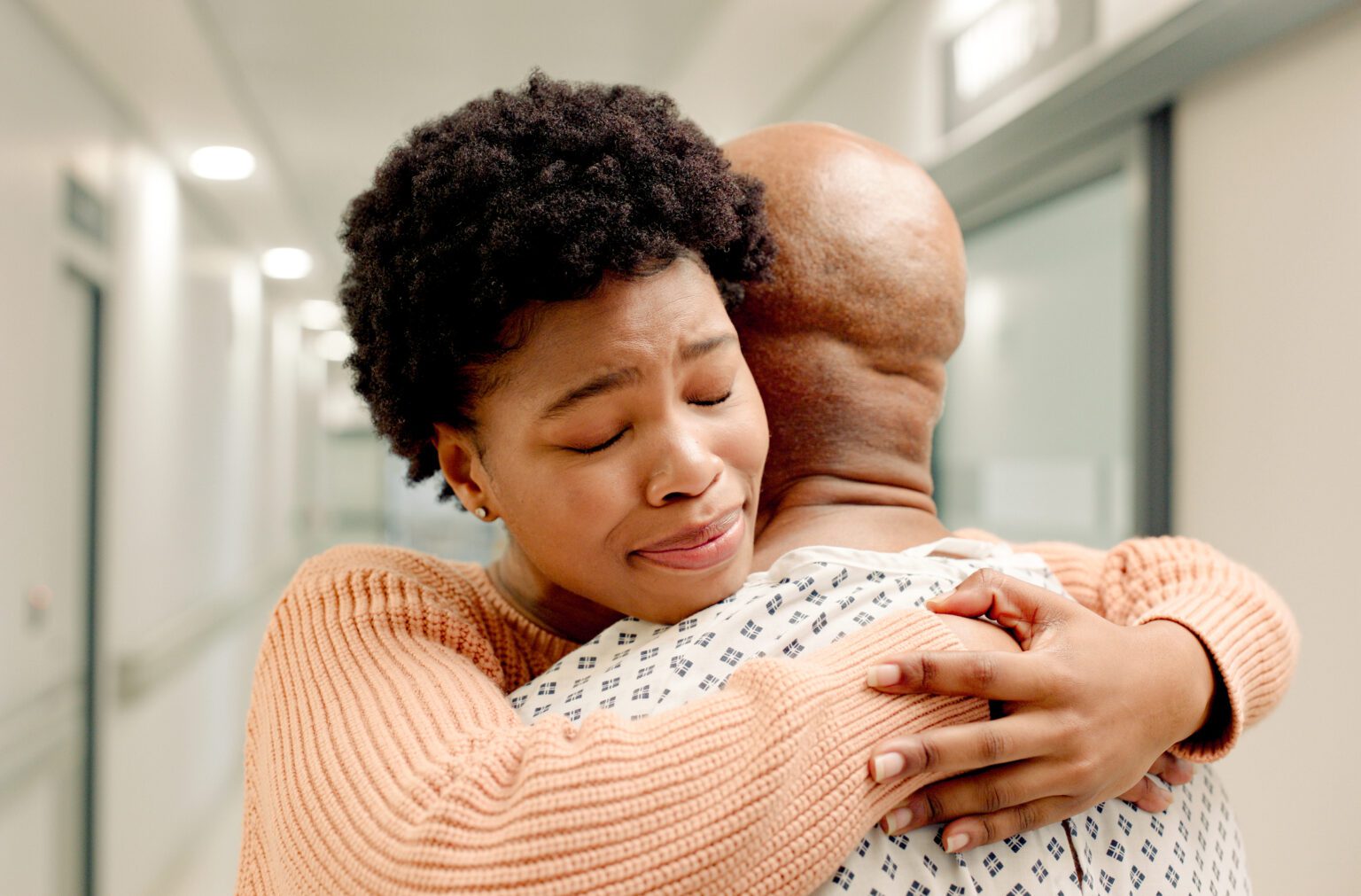 Woman hugging hospital patient