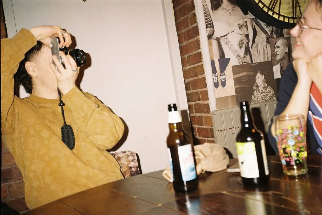 Young man using a film camera